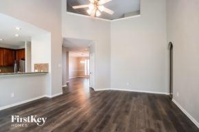 Crosby house for rent - an empty living room with hardwood flooring and a ceiling fan