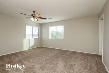 Buckeye house for rent - a living room with carpet and a ceiling fan