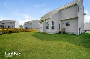 Reynoldsburg house for rent - A FirstKey Homes sign is on a house in a grassy yard.