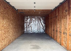 Longview apartment for rent - A room under construction with wooden panels on the walls and a silver tarp in the middle.