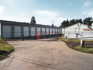 Longview apartment for rent - A large industrial building with a red and white sign on the side.