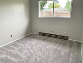 Longview house for rent - an empty room with carpet and a large window