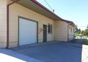 Longview house for rent - A small house with a red roof and a white garage door.