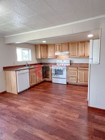 Longview house for rent - A kitchen with wooden cabinets and a refrigerator.