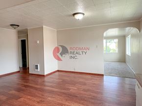 Longview house for rent - A room with Rodman Realty Inc. logo on the wall.