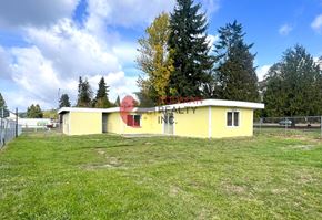 Longview house for rent - A small yellow building with a red roof and the words "BRODMAN FARM" on it.