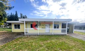 Longview house for rent - A building with a sign that reads "REAL ESTATE INC." is shown.