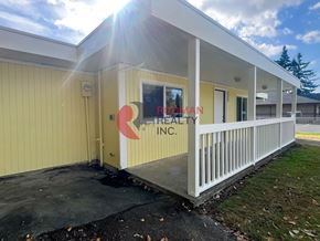 Longview house for rent - A building with a red and white logo on the side.