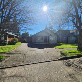 Longview house for rent - A sunny day in a residential area with houses and bare trees.