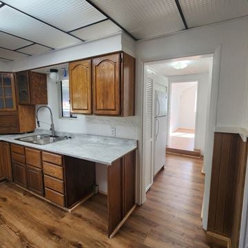 Longview house for rent - A kitchen with wooden cabinets and a marble countertop.