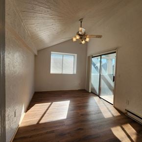 Longview house for rent - A room with wooden floors and a ceiling fan.