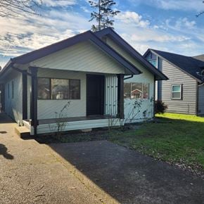 Longview house for rent - A small house with a porch and a tree in the front yard.