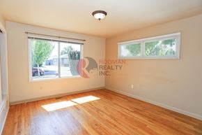 Longview house for rent - A room with wooden floors and a window with blinds.