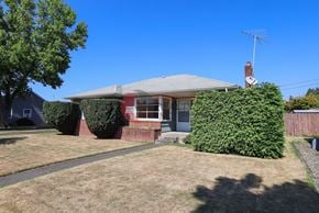 Longview house for rent - A house with a grey roof and a red brick chimney.