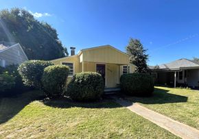 Longview house for rent - a house with three bushes in front of it