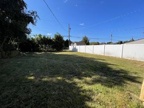 Longview house for rent - a backyard with a white fence and a grassy yard