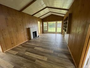 Longview house for rent - a living room with wood floors and a fireplace