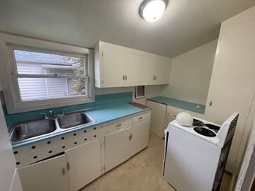 Longview house for rent - a kitchen with white appliances and blue counter tops