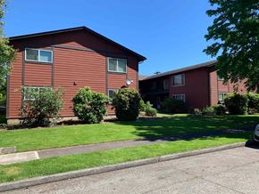 Longview apartment for rent - A red building with a white door and windows.