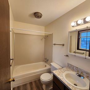 Longview apartment for rent - A bathroom with a toilet, sink, and bathtub.