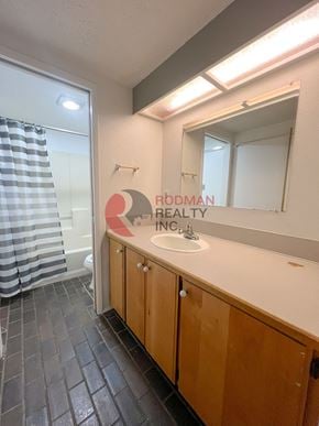 Longview house for rent - A bathroom with Rodman Realty Inc written on the mirror.