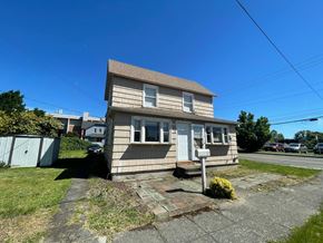 Kelso apartment for rent - a small tan house with a road in front of it