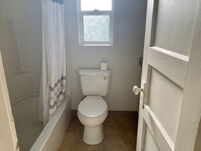 Longview house for rent - a small bathroom with a toilet and a shower