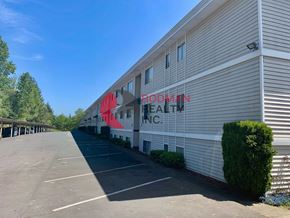 Longview apartment for rent - A Rodman Health Inc. building with a parking lot in front.