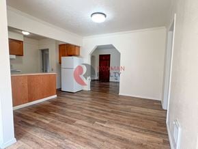Longview house for rent - A room with wooden flooring and a white ceiling with a light fixture.