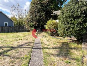 Castle Rock apartment for rent - A red sign with the word "RETAIL" is in the foreground of a grassy area with a pathway leading to a house.