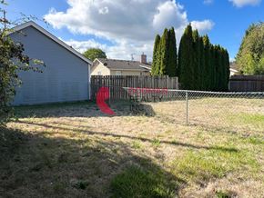 Castle Rock apartment for rent - A backyard with a fence and a tree.
