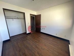Longview house for rent - A room with a sliding door and a wooden floor.