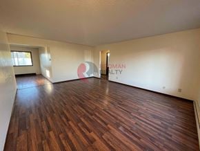 Longview house for rent - A room with wooden flooring and a large window.