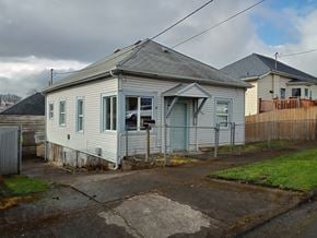 Kelso house for rent - a small white house with a fence in front of it