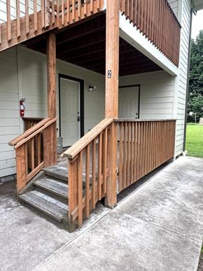 Kelso apartment for rent - A wooden staircase leading to a door on the second floor of a house.