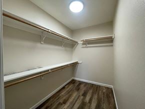 Kelso apartment for rent - A walk-in closet with white walls and wooden shelves.