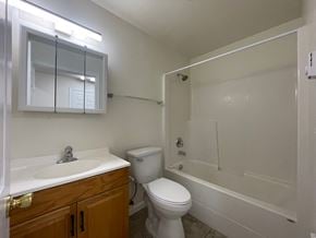 Kelso apartment for rent - A white toilet sits next to a sink in a small bathroom.