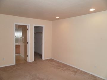 Longview house for rent - a living room with a carpet and a door to a bathroom