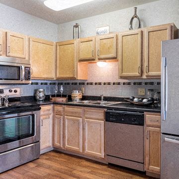Memphis apartment for rent - A kitchen with wooden cabinets and black countertops.