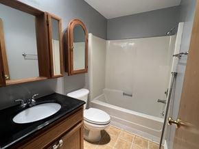 Longview apartment for rent - A bathroom with a toilet, sink, and bathtub.