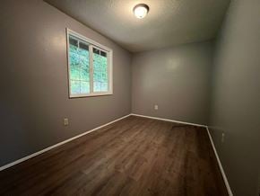 Longview apartment for rent - A room with a window and wooden flooring.