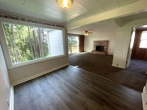 Longview house for rent - A room with a fireplace and a ceiling fan.