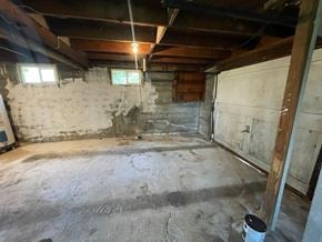 Longview house for rent - A room with a concrete floor and walls, a window, and a door.