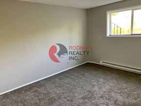 Kelso apartment for rent - A room with Rodman Realty Inc. logo on the wall.