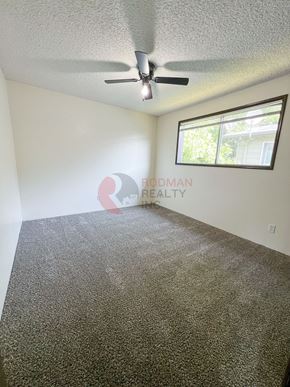 Longview apartment for rent - A room with a ceiling fan and a window.