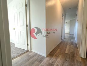 Longview apartment for rent - A hallway with Rodman Realty Inc. on the wall.