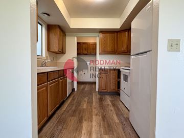 Longview apartment for rent - A kitchen with wooden cabinets and a white refrigerator.