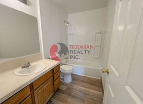 Longview apartment for rent - A bathroom with Rodman Realty Inc. written on the wall.