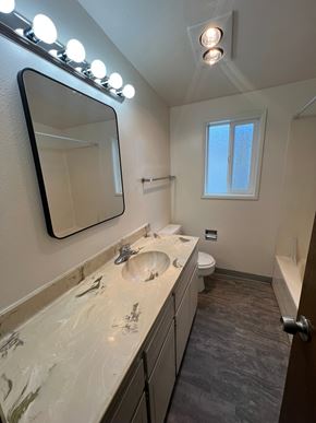 Longview apartment for rent - A bathroom with a sink, mirror, and lights.