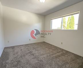 Longview apartment for rent - A room with Rodman Realty Inc. logo on the wall.
